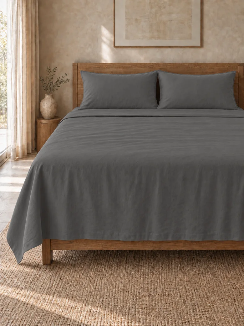 Indian cotton flat sheet set in Charcoal on a wooden bed